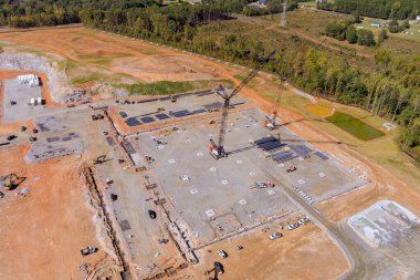 İnşaat alanının bu panoramik görünümünde yüksek binalarda çalışan büyük vinçleri görebilirsiniz.