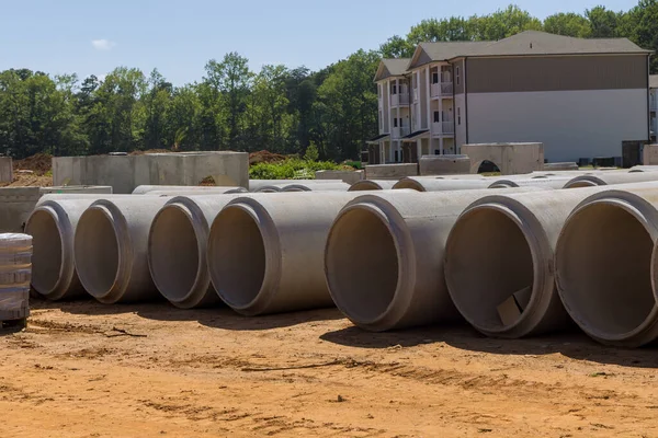 Concrete cement sewage pipes are used to construct drainage systems for industrial buildings on construction site in order dispose of waste water.