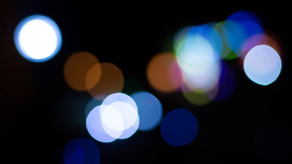 Abstract evening night shimmering bokeh background effect street outside near cafe restaurant. Defocused urban city life blur golden light bulbs garlands. Christmas New Year party holiday concept.