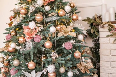 Konforlu daire yeşil Noel Ağacı hediyeleri çelenkler, mumlar dekore edilmiş oyuncaklar iç mekan yeni yıl oturma odası akşam parlayan ışıklar bokeh