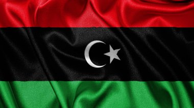 Libya 'nın dalgalanan arka planının gerçekçi kumaş kumaş kumaş ipek saten bayrağını kapatın. Ülkenin ulusal sembolü. 24 Aralık, Mutlu Günler konsepti