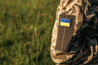 Close up velcro patch with flag of Ukraine on military uniform soldiers arm. Armed Forces of Ukraine. Ukrainian in Army.