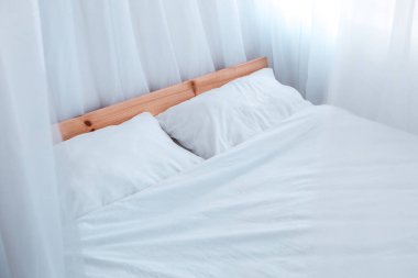 Luxury home modern bedroom interior appartments white bed linens pillows sunny day sunshine through window well lit room with cosy atmosphere spike 