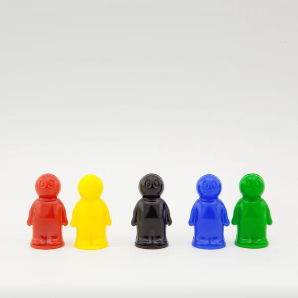 Colorful plastic toy people on white background — Stock Photo, Image