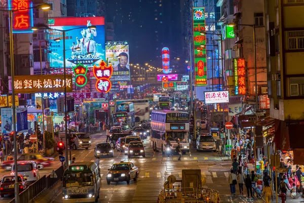 Hong Kong, China - March 16, 2013: Street Scene in Mongkok. Colorful shopping street Illuminated at night. Mongkok is a district in Hong Kong and has the highest population density in the world
