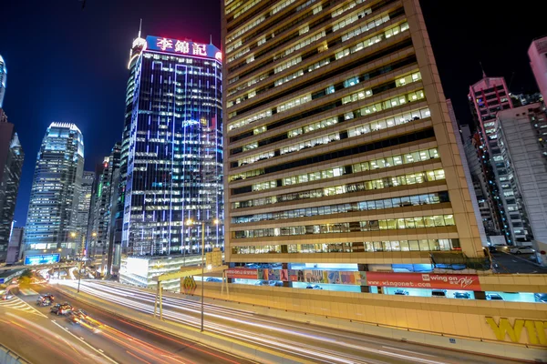 Night traffic with long shutter at Sheung Wan Car Park. Hong Kong is a 24 hours living city. — Stock Photo, Image
