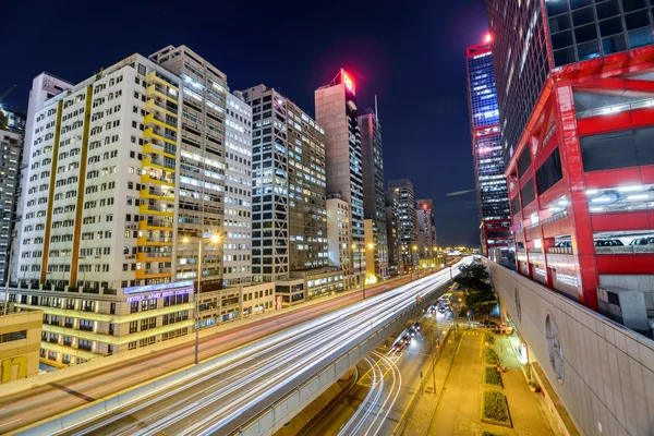Night traffic with long shutter at Sheung Wan Car Park. Hong Kong is a 24 hours living city. — Stock Photo, Image