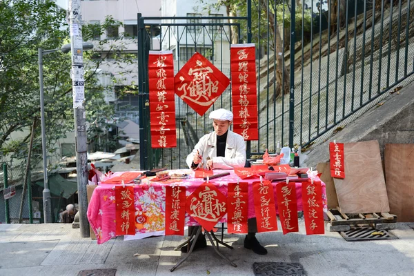 Writing Chinese New Year antithetical couplets — Stock Photo, Image