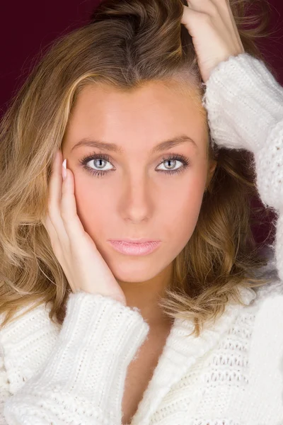 A young girl in a white sweater — Stock Photo, Image