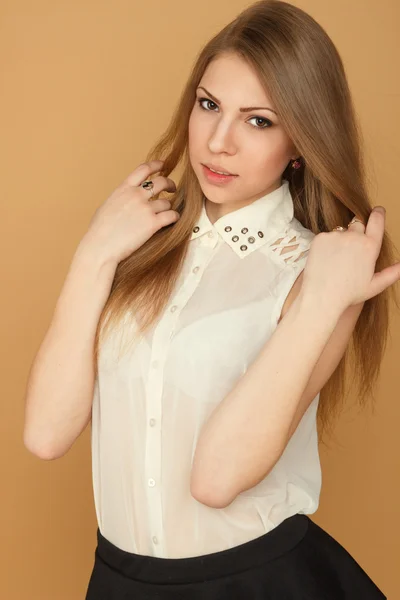 A beautiful young girl in a white blouse — Stock Photo, Image