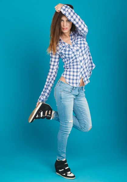 Beautiful girl in a shirt and jeans posing — Stock Photo, Image