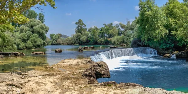 Güneşli bir yaz gününde Türkiye 'nin Antalya ilinde Manavgat şelalesi ve nehri