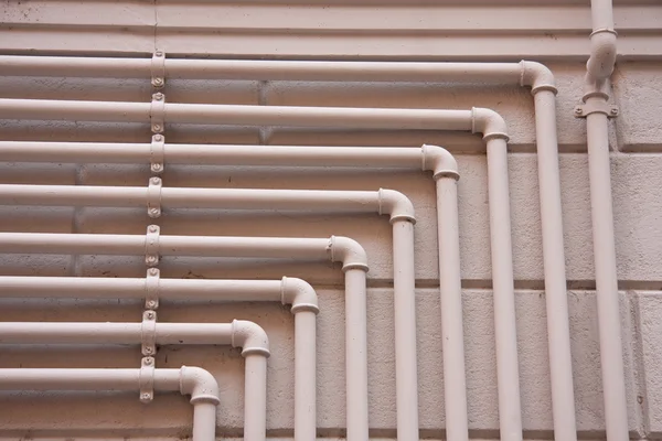 Steel gas pipes on a building wall — Stock Photo, Image