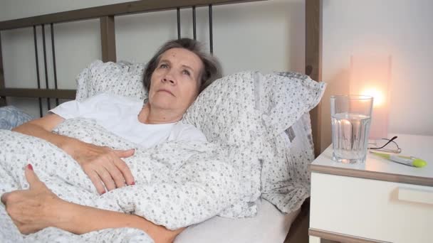 主题是注意力不集中 年长的老年妇女在家中卧床休息 疲倦的病患者孤独地退隐 以及照顾不快乐忧郁的病毒 包含噪音 — 图库视频影像