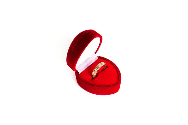 Golden wedding ring in a red heart-shaped jewelry box isolated on a white background. Royalty Free Stock Images