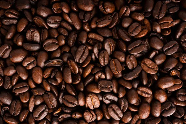 Kávová zrna pozadí. Spousta kávových zrn. — Stock fotografie