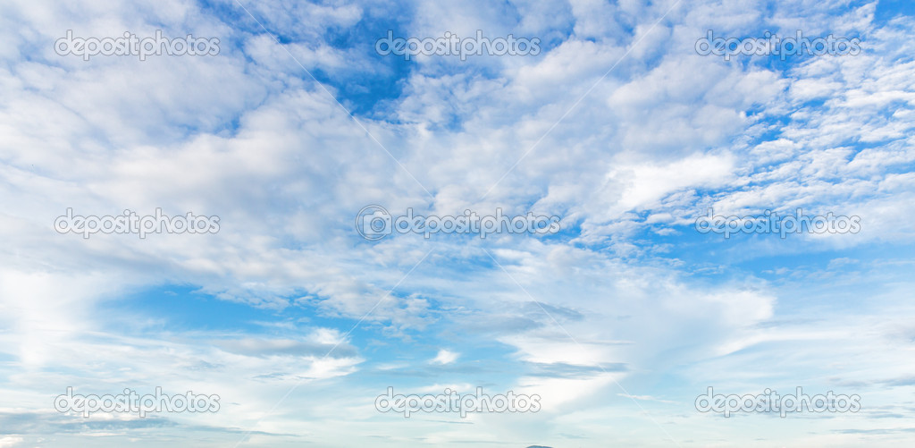 Blue sky background with a tiny clouds