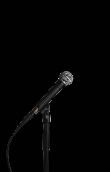 Dynamic vocal microphone on a stand with black background — Stock Photo, Image