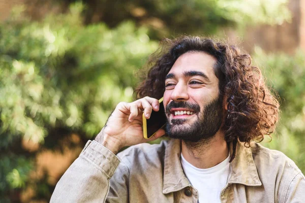 Positive bearded male talking on mobile phone — Foto de Stock