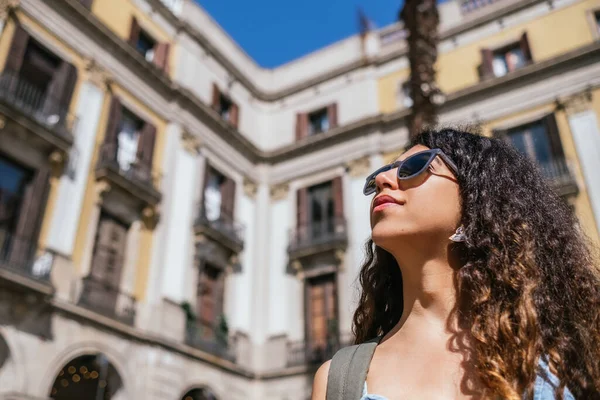 Young Dark Curly Haired Woman Wearing Sunglasses Looking Away She — Stock Fotó