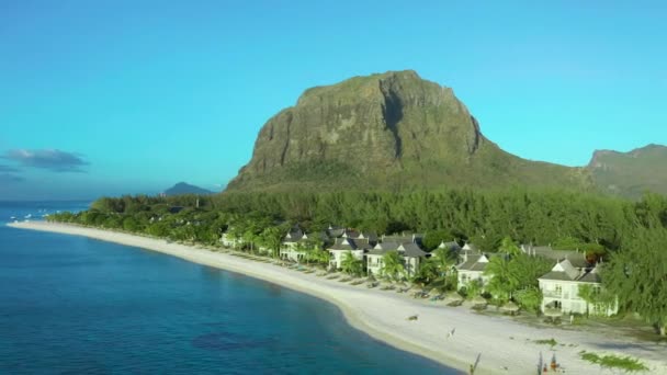 Flygfoto. Paradisets klippiga tropiska ö vid solnedgången. Havsvågor och Le Morne Brabant vid solnedgången. Mauritius. — Stockvideo