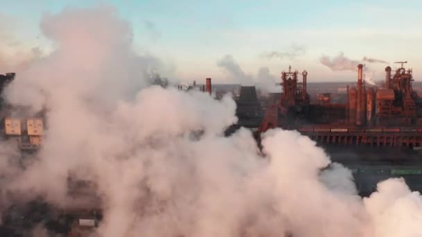 Drone around toxic enterprise chimneys tubing against the sky background release black smoke. Factory pollutes environment. Ecology pollution concept — 图库视频影像