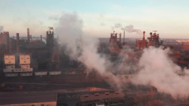 Drone around toxic enterprise chimneys tubing against the sky background release smoke. Factory pollutes environment. Aerial view — 图库视频影像