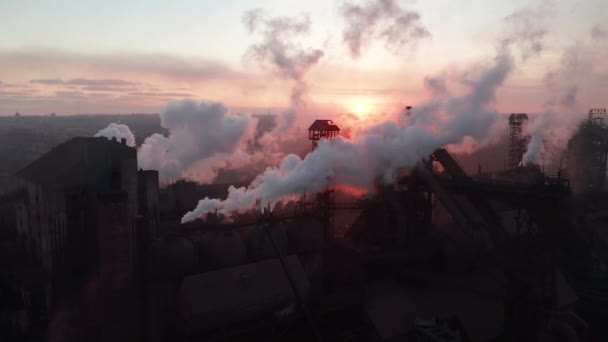 Drone around toxic enterprise chimneys tubing against the sky background release smoke. Factory pollutes environment. Aerial view — Stockvideo