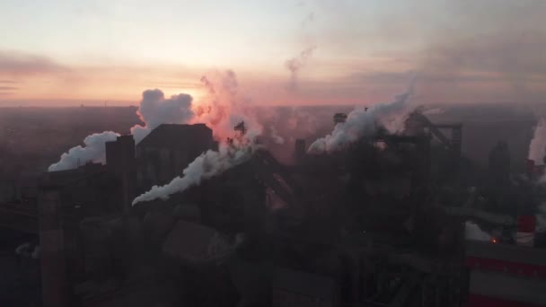 Drone around toxic enterprise chimneys tubing against the sky background release black smoke. Factory pollutes environment. Ecology pollution concept — Stockvideo