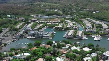 Okyanus mavisi şeffaf su ve hareket eden motor beyazı yatın havadan görünüşü, kamera orman, palmiye ağaçları, kumsal, Mauritius Adası kıyılarına doğru hareket ediyor. Grande Riviere Noire, Mauritius Adası