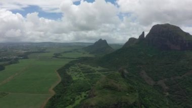 Tepeden tırnağa Mauritius ormanları ve dağların zirveleri, bulutların içindeki gökyüzü. Dağın zirvesine doğru uç.