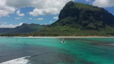 Mauritius adasının arka planında turkuaz su katamaranı var. İHA görüntüleri açık denizde yüzen katamaranların havadan görüntüsü..