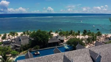 Beyaz kumlu güzel tropikal adanın havadan görünüşü, oteller ve turistler. Turkuaz suyu ve beyaz kumu olan tropik bir göl. Güzel gökyüzü, deniz, sahil, tatil köyü