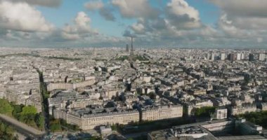 Aerial drone distant sunset view of Tour Eiffel Tower and Seine River bridge traffic cars driving, Paris city attractions, France. High quality 4k footage