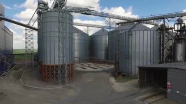 Storage facility for soy and wheat grains. Harvesting. Grain elevator aerial view. A tank for wheat grain. Grain storage facilities. Oil plant.