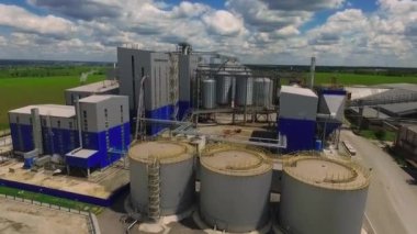 Storage facility for soy and wheat grains. Harvesting. Grain elevator aerial view. A tank for wheat grain. Grain storage facilities. Oil plant.