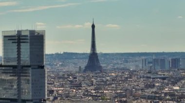 Aerial drone distant sunset view of Tour Eiffel Tower and skyscraper, Paris city attractions, France. Historic Parisian city center from above during warm summer. Famous holidays vacation destination.