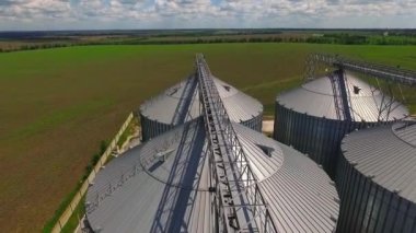 Storage facility for soy and wheat grains. Harvesting. Grain elevator aerial view. A tank for wheat grain. Grain storage facilities. Oil plant.