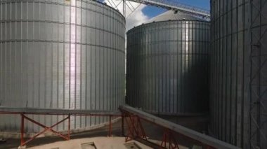 Storage facility for soy and wheat grains. Harvesting. Grain elevator aerial view. A tank for wheat grain. Grain storage facilities. Oil plant.