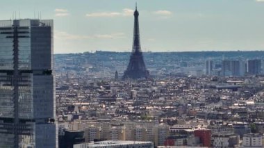 Aerial drone distant sunset view of Tour Eiffel Tower and skyscraper, Paris city attractions, France. Historic Parisian city center from above during warm summer. Famous holidays vacation destination.