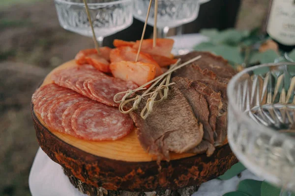 Cutting food on a wooden board at a banquet