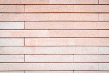 Pembe ve şeftali rengi duvar dokusu. Pastel tonlar. Güzel, şık, hassas bir fon. Alçı ve boyayla kaplı parlak taş bir yapı. İnşaat malzemeleri. Kapat, boşluğu kopyala