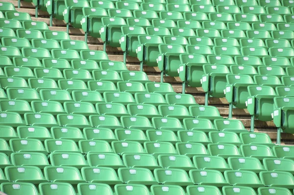 Линия зеленых пластиковых стульев — стоковое фото