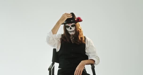Young Guy Skeleton Makeup Long Hair Looking Camera Taking Hat — Stock Video