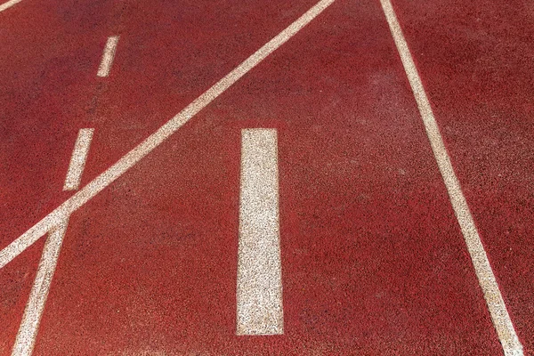 Número uno al inicio de una pista de atletismo — Foto de Stock