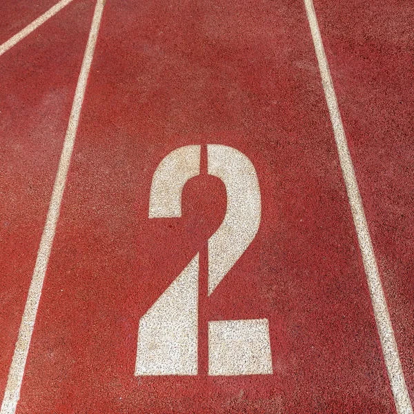 Number 2 on red running track — Stock Photo, Image
