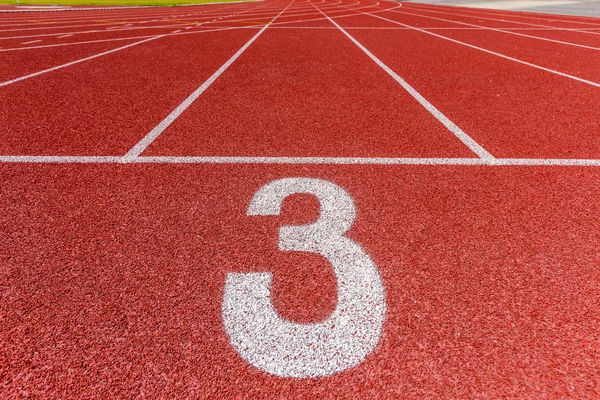 Number three on the start of a running track — Stock Photo, Image