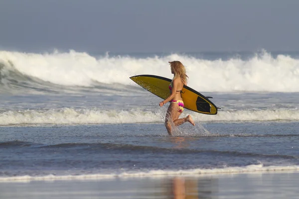 Female surfer on beach — Stock Photo, Image