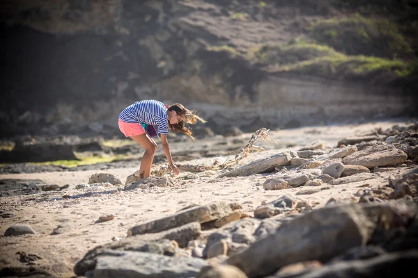 Kvinde går alene på en øde strand - Stock-foto