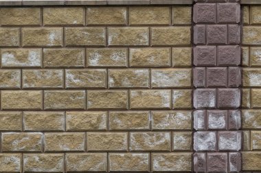 A photo illustrating efflorescence on a brick and block wall.  Salt effloresced on the bricks and blocks. clipart